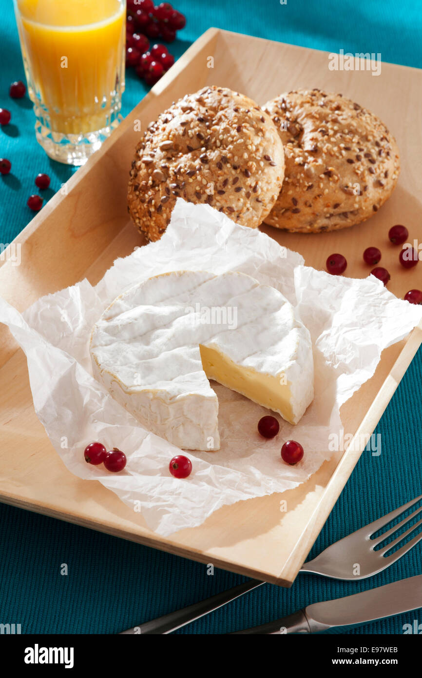 camembert cheese with brown bread and red current Stock Photo