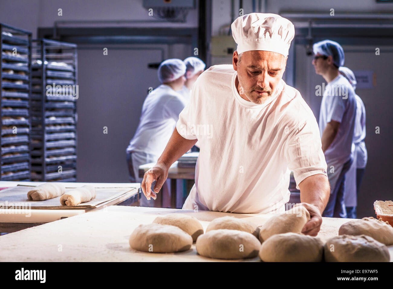 Baking bread, chef controlling dough Stock Photo