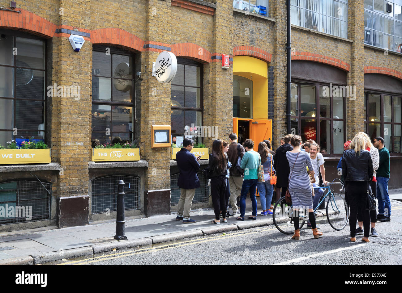 People queuing outside the Breakfast Club on Rufus Street, in trendy Hoxton, in east London, UK Stock Photo