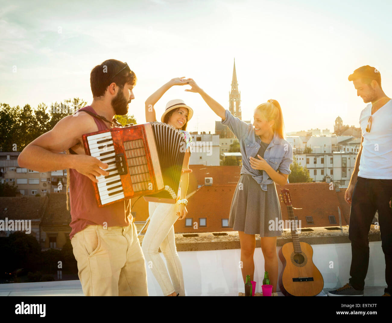 Young people having fun at rooftop party Stock Photo