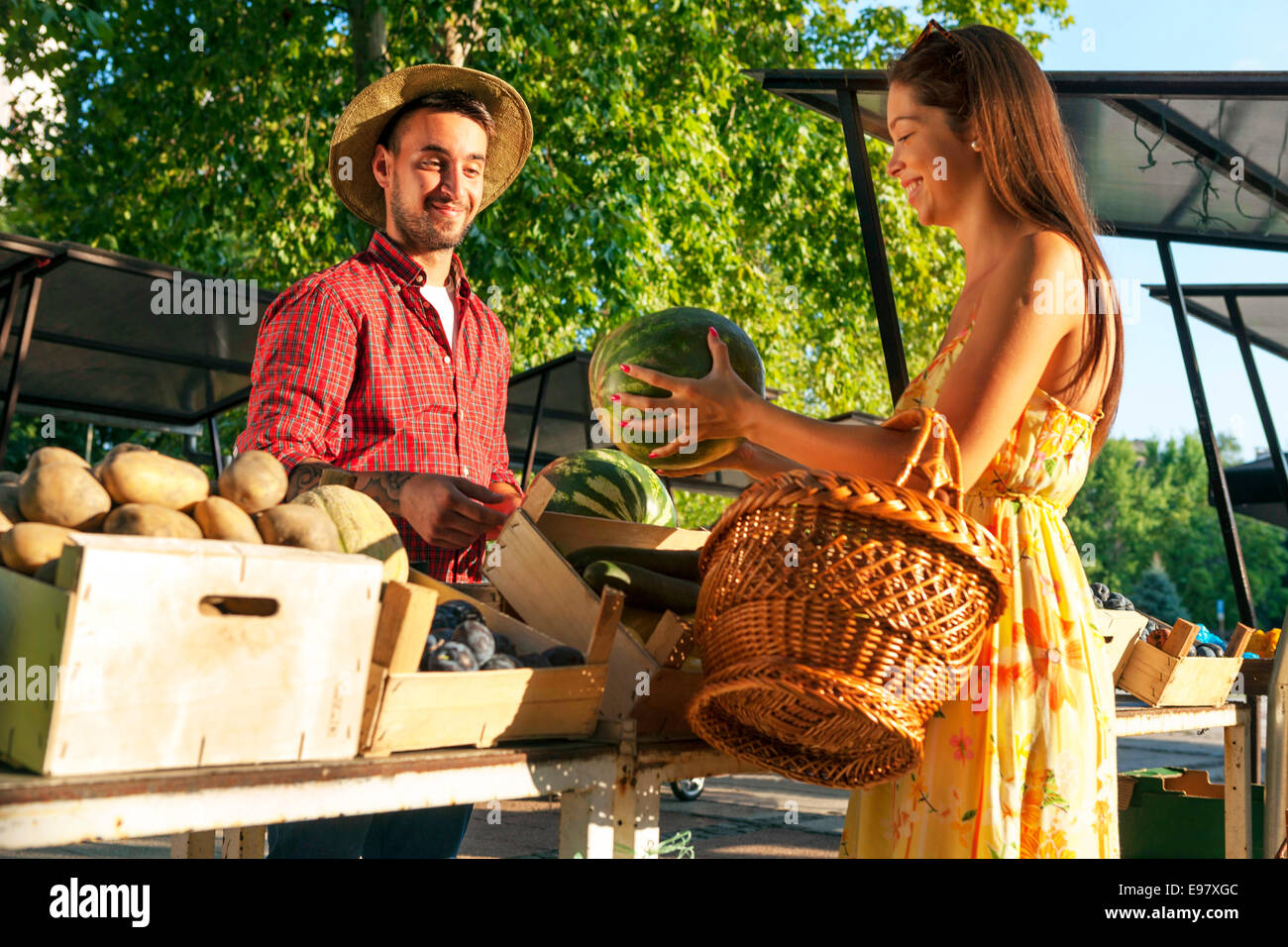 Young man selling fruit and vegetables at market stall Stock Photo - Alamy