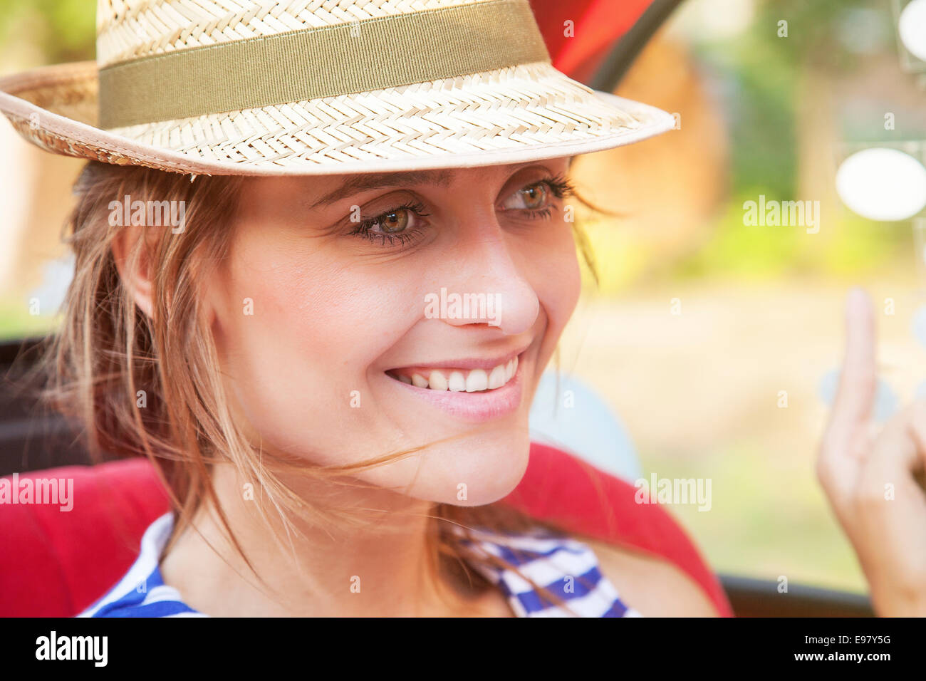Portrait of happy young woman with sun hat Stock Photo - Alamy