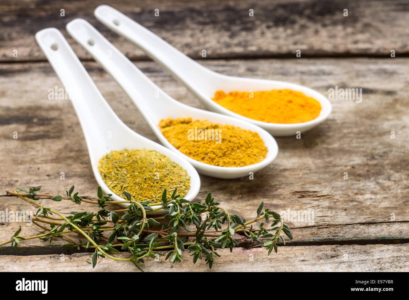 Spices recipe background. Diversity of spice powder mix with branch of thyme Stock Photo