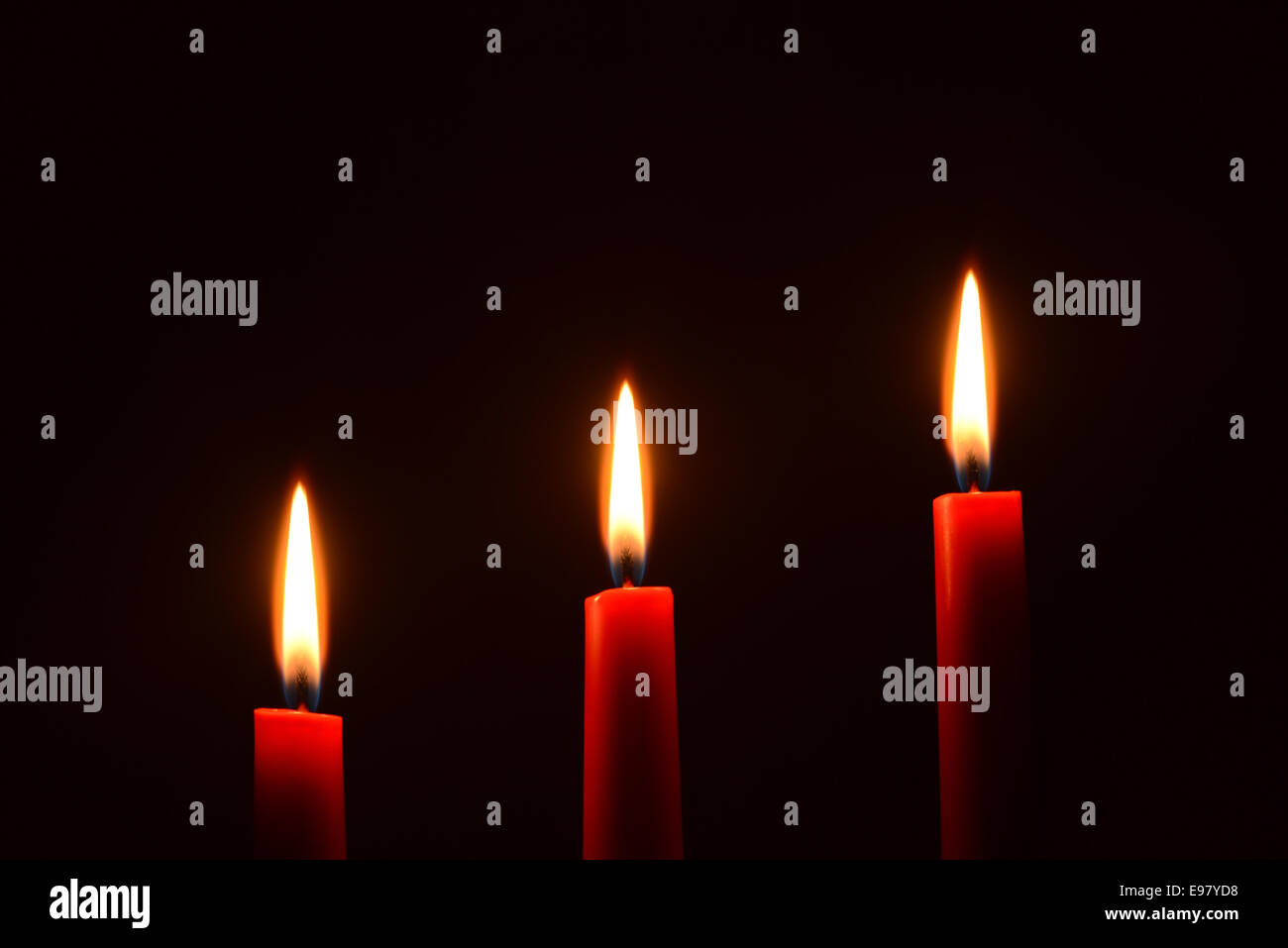 Three red candles on a black background Stock Photo Alamy