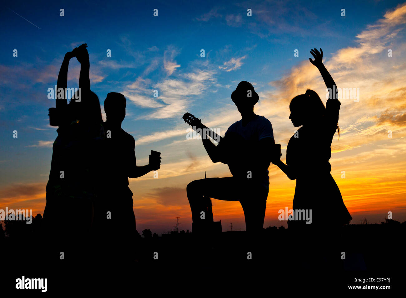Young people dancing and having fun at sunset Stock Photo