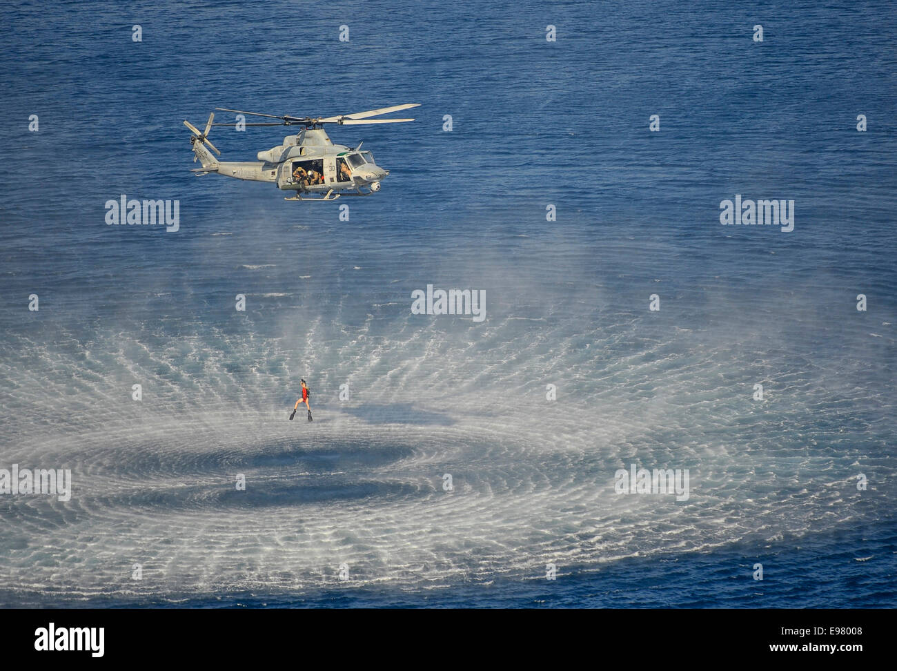 Marine Corps UH-1Z Venom helicopter winching a U.S. Naval Aircrewman Stock Photo