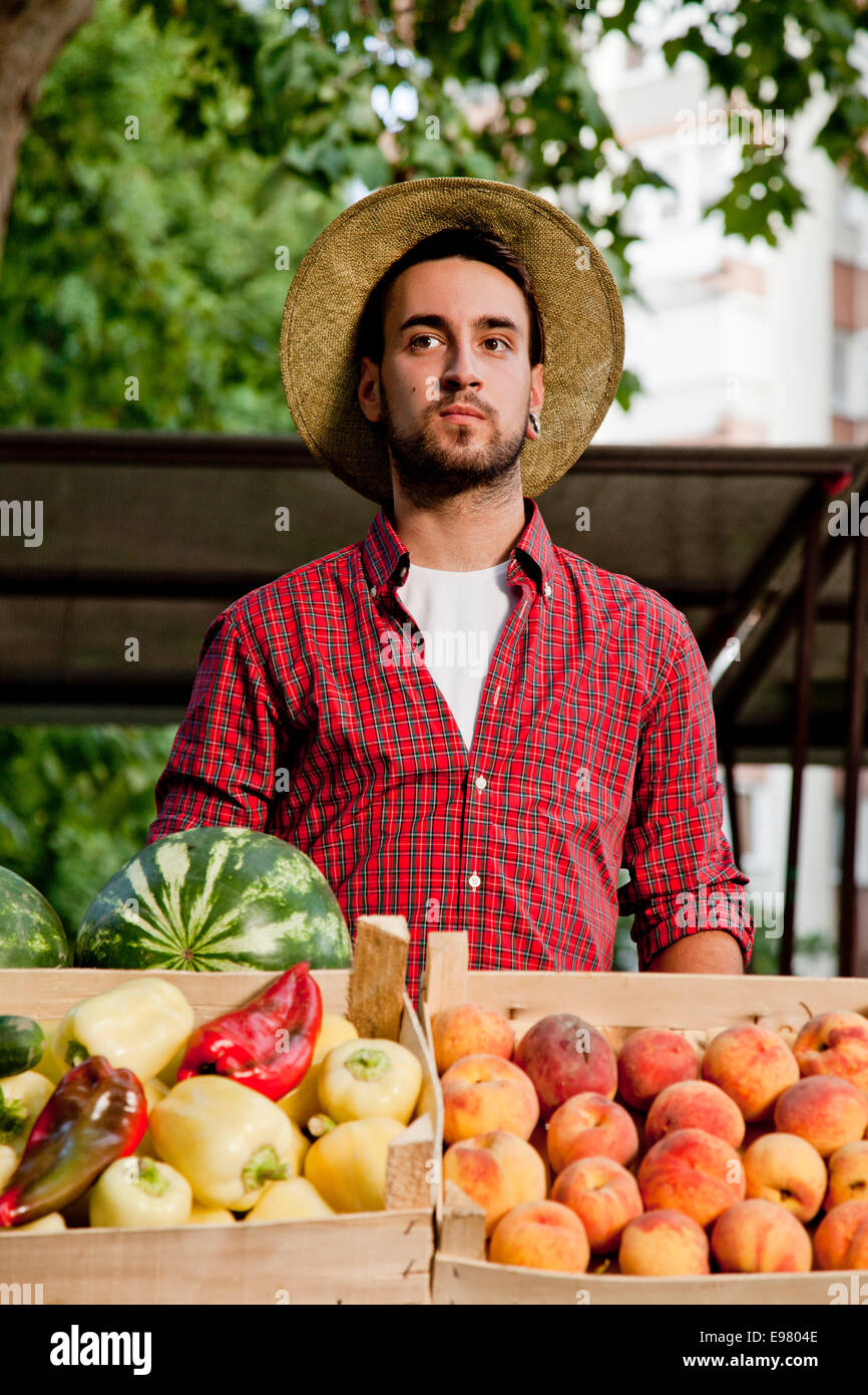 Young man selling fruit and vegetables at market stall Stock Photo Alamy