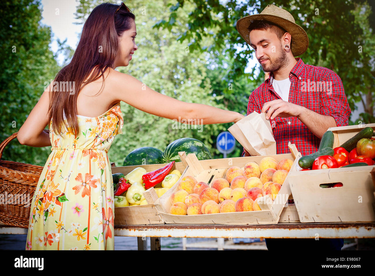 Woman buying fruit at market stall Stock Photo