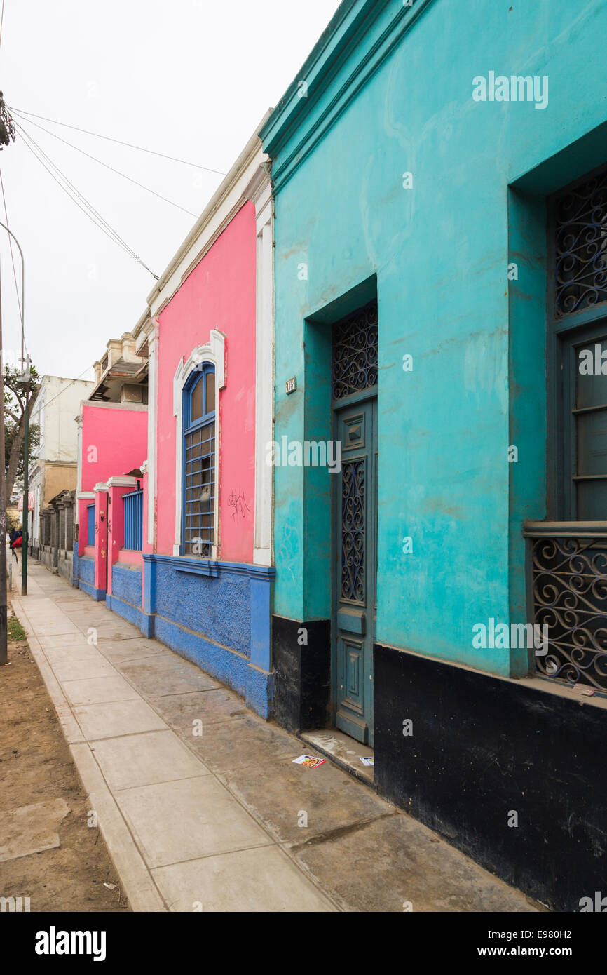 Colourful, brightly coloured local terraced houses and buildings in a street in Barranco, a suburb of Lima, Peru Stock Photo