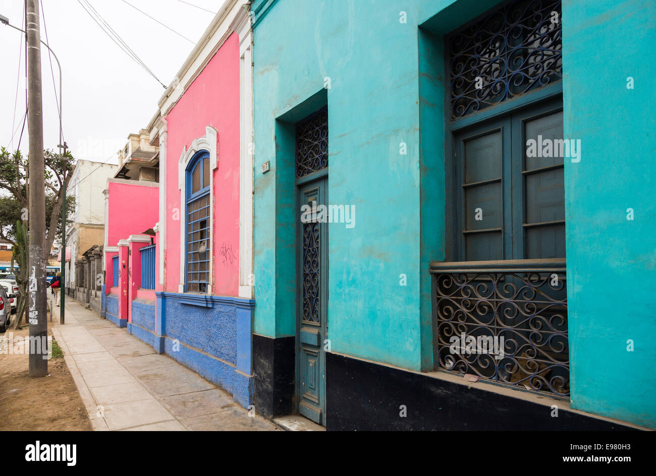 Colourful, brightly coloured local terraced houses and buildings in a street in Barranco, a suburb of Lima, Peru Stock Photo