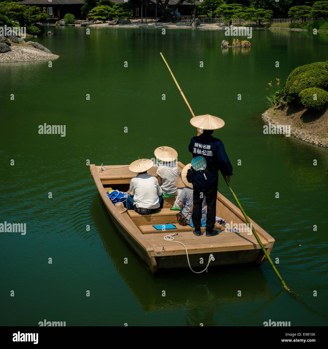 Visitors enjoy a cruise on a lake in the Ritsurin Garden, Takamatsu. Stock Photo