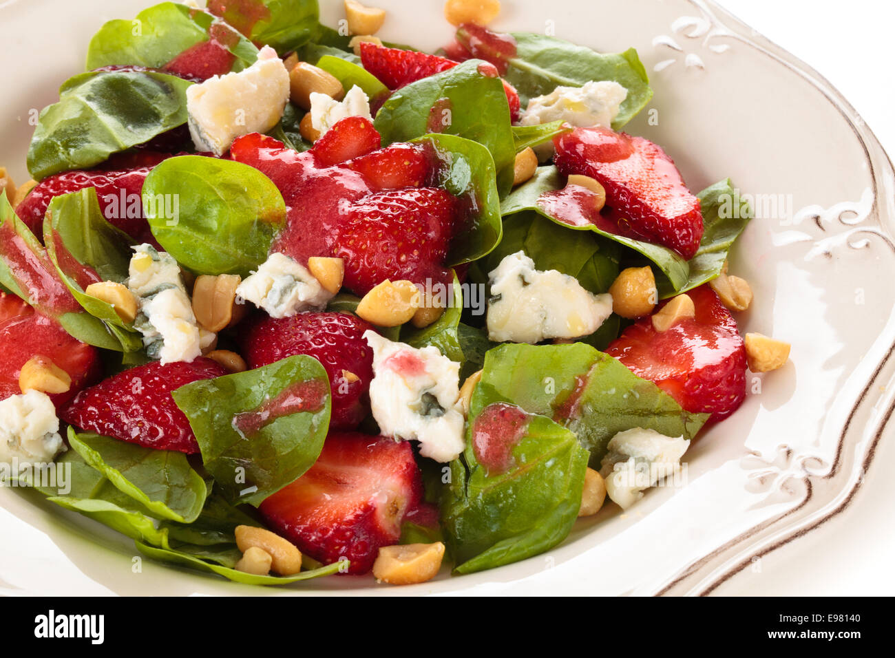 Fresh spinach salad with peanuts and blue cheese. Stock Photo