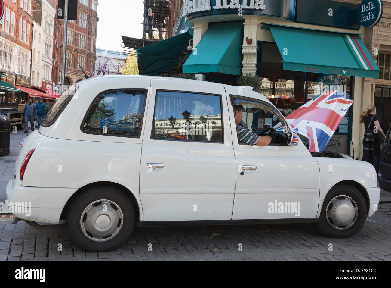 A white London Taxi, black cab, with an open engine hood. Stock Photo