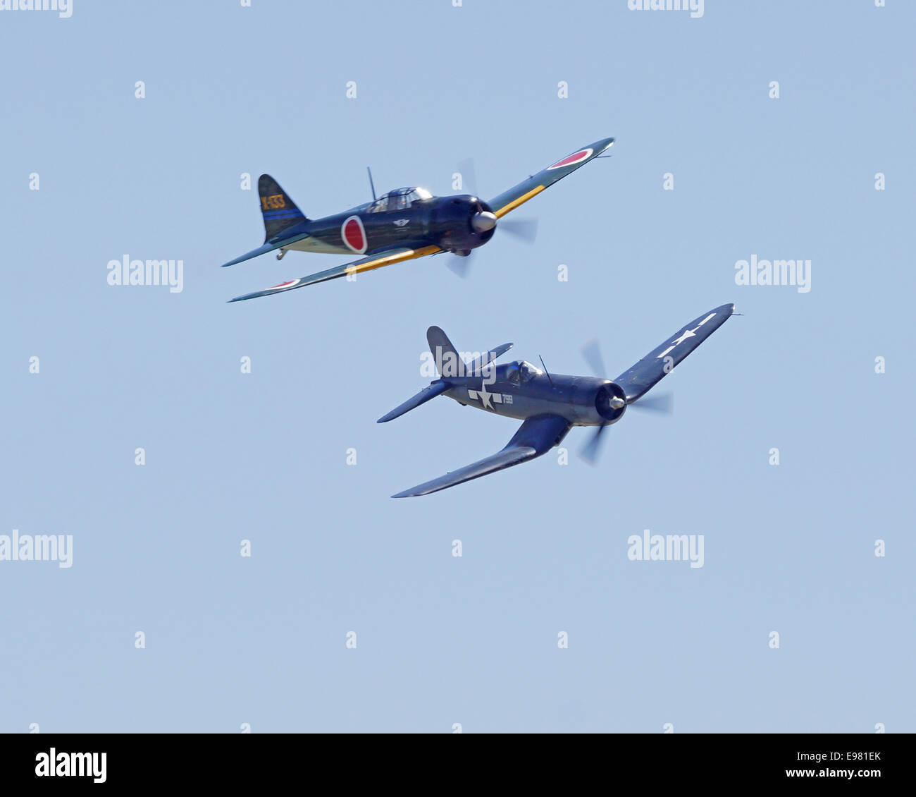Vintage WWII F4U US Fighter and Japanese Zero Aircraft flying at 2014