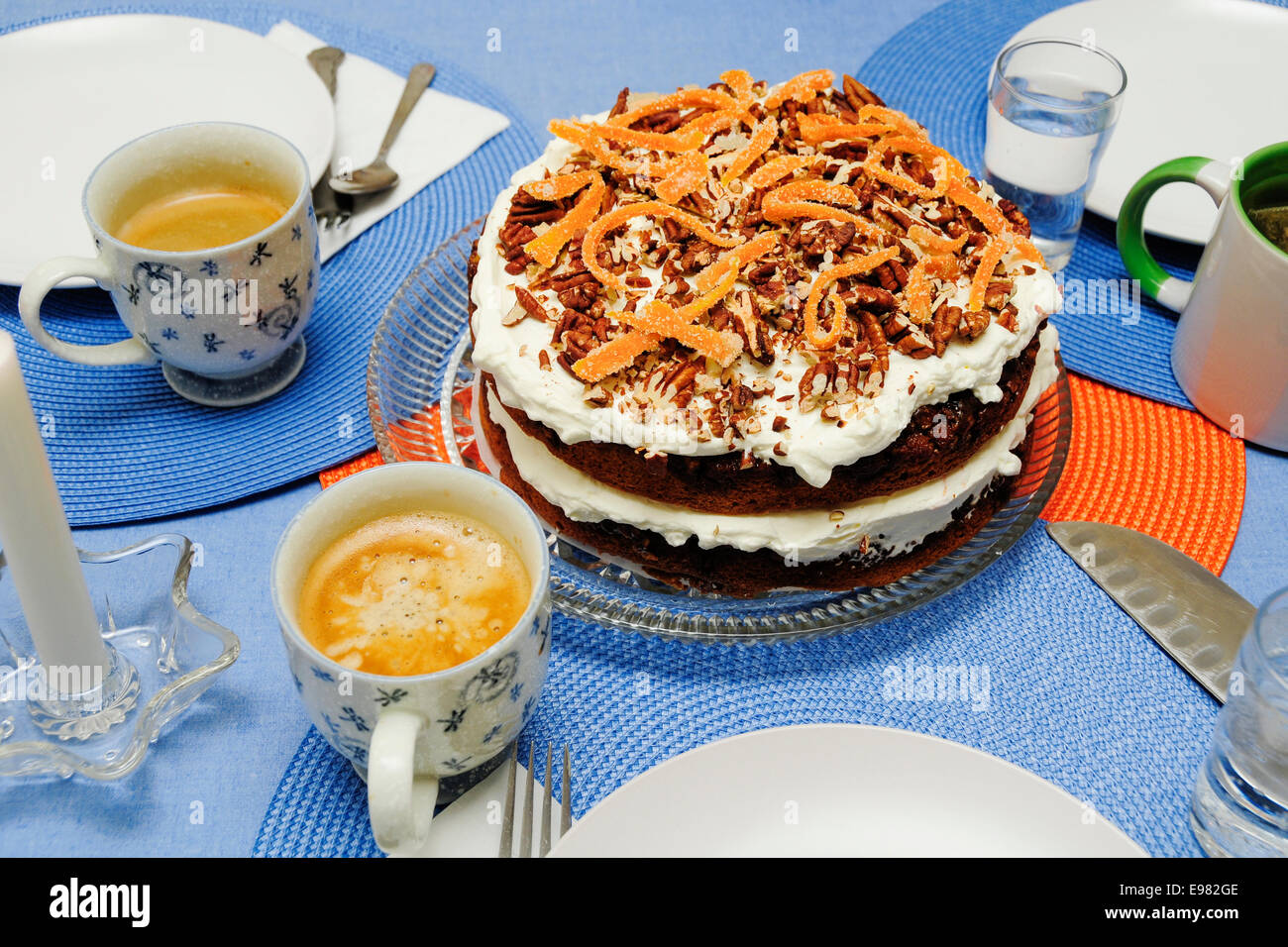 Blue circular place mats are set in geometric pattern irage placement in center. In center is fancy chocolate cake white Stock Photo