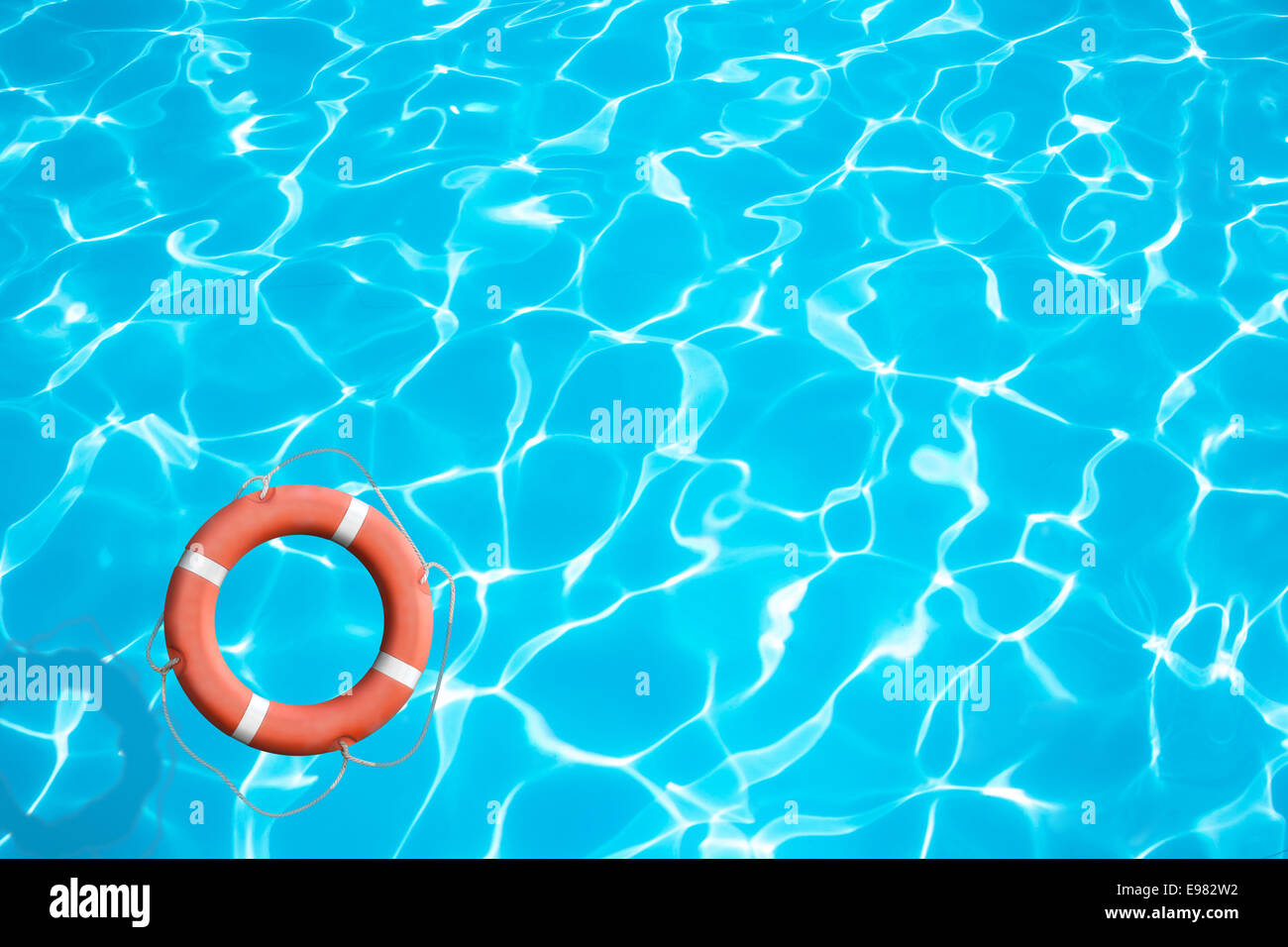 Lifebuoy on blue water surface concept Stock Photo