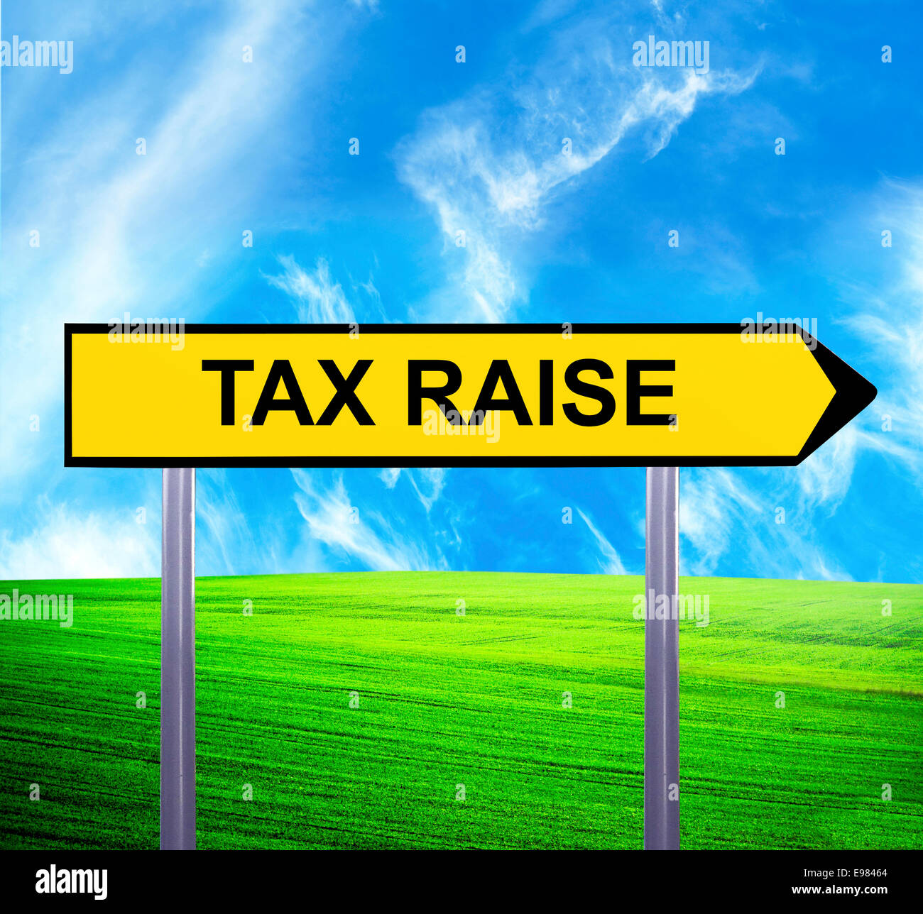 Conceptual arrow sign against beautiful landscape with text - TAX RAISE Stock Photo