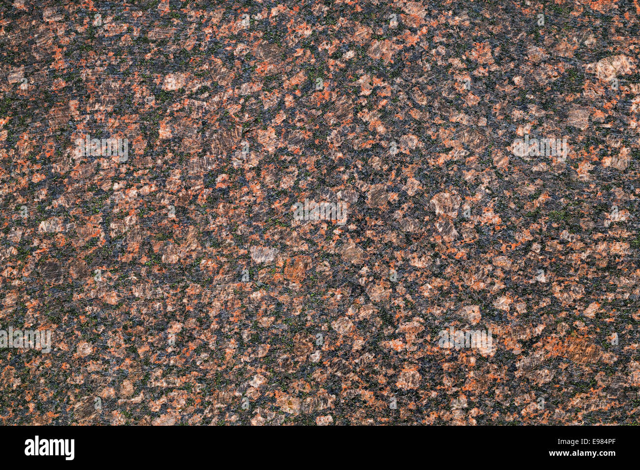 Dark red granite stone, closeup background texture Stock Photo