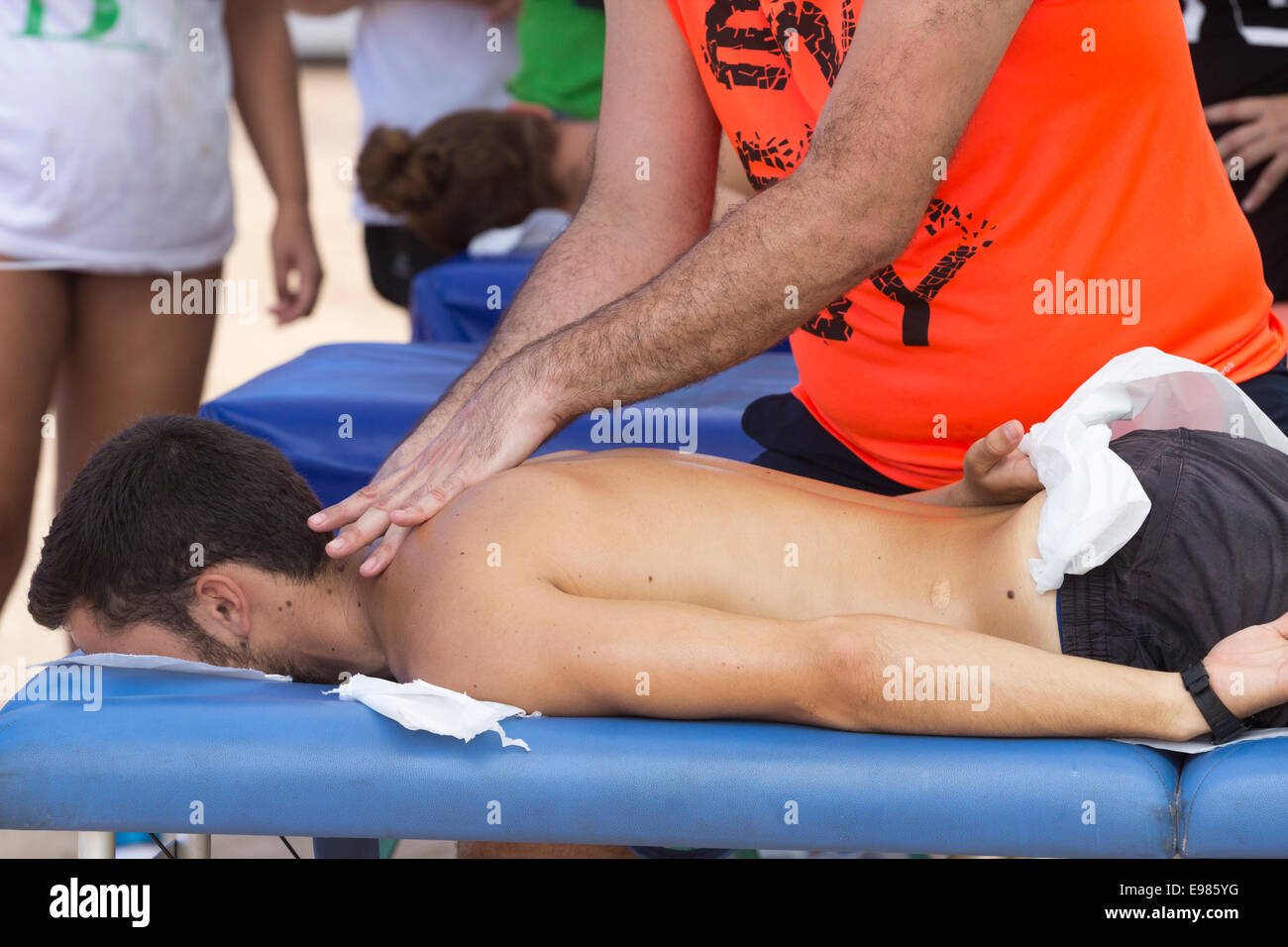 Surfer having massage at competition in Spain Stock Photo
