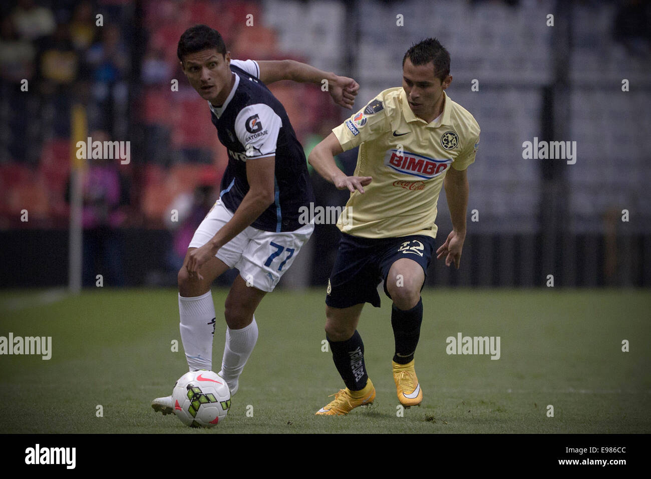 Mexico City, Mexico. 21st Oct, 2014. America's Paul Aguilar (R), vies for the ball with Guatemala's Comunicaciones Jairo Arreola (L) during a CONCACAF Champions League soccer match held at Estadio Azteca, in Mexico City, capital of Mexico, on Oct. 21, 2014. © Alejandro Ayala/Xinhua/Alamy Live News Stock Photo
