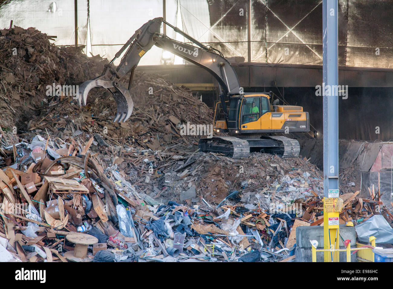 Garbage being sorted by backhoe, Downtown Los Angeles, California, USA Stock Photo