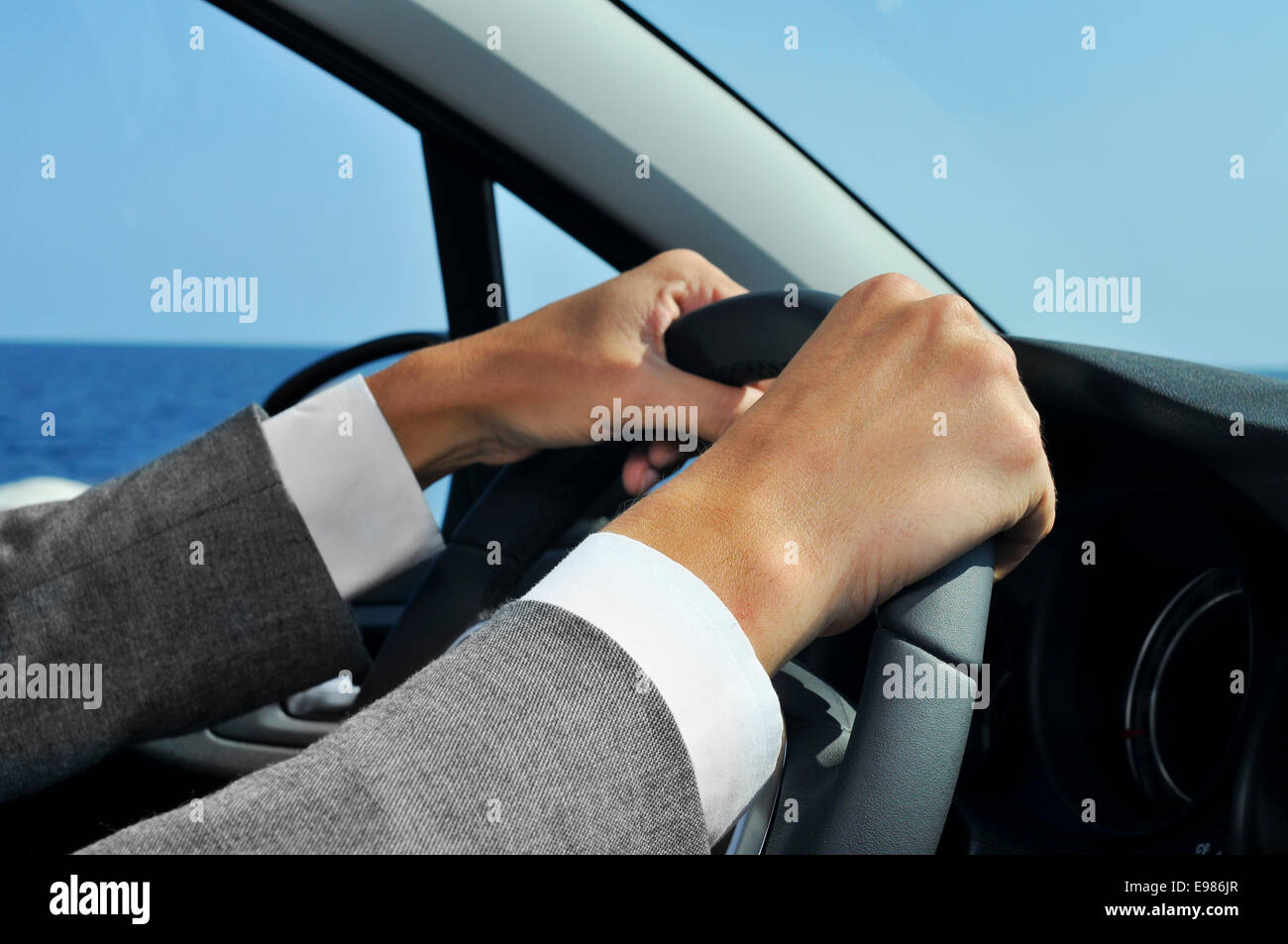 closeup of a man in suit driving a car Stock Photo