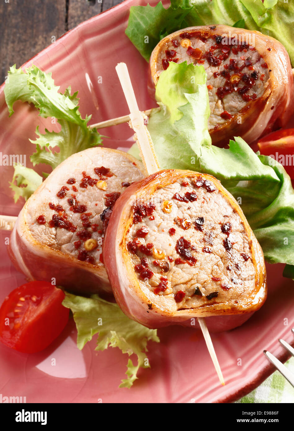 Close up of a meal of pork meat. Tasty fillet of pork wrapped in bacon