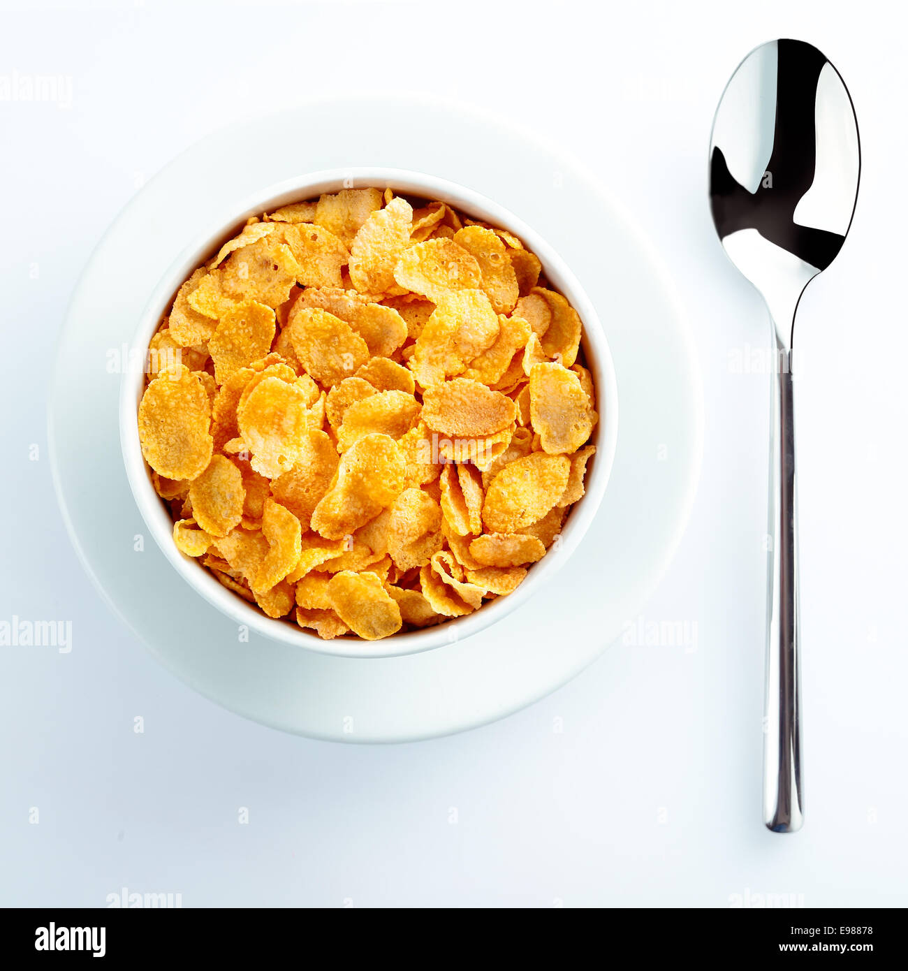 Bowl of cereal and spoon waiting for milk set on the table for a nutritious breakfast Stock Photo