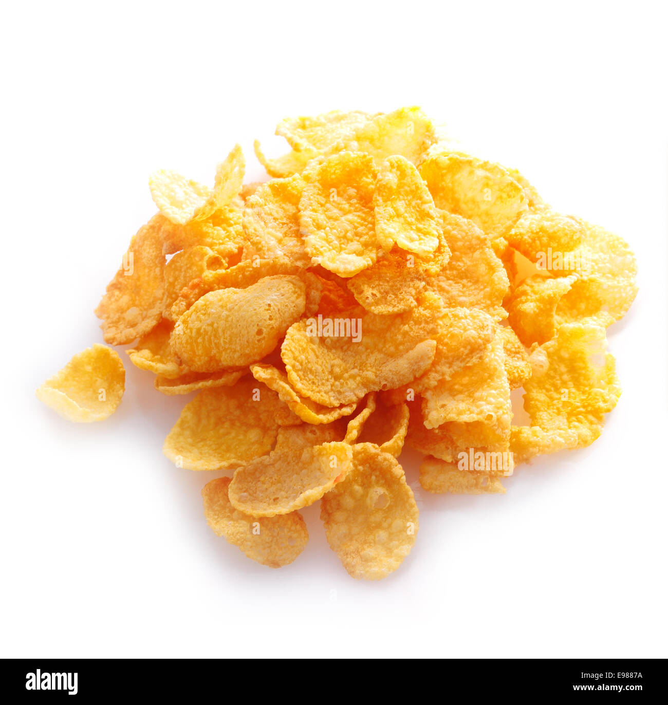 Small sampling of corn flake cereal in a pile isolated against a white background Stock Photo