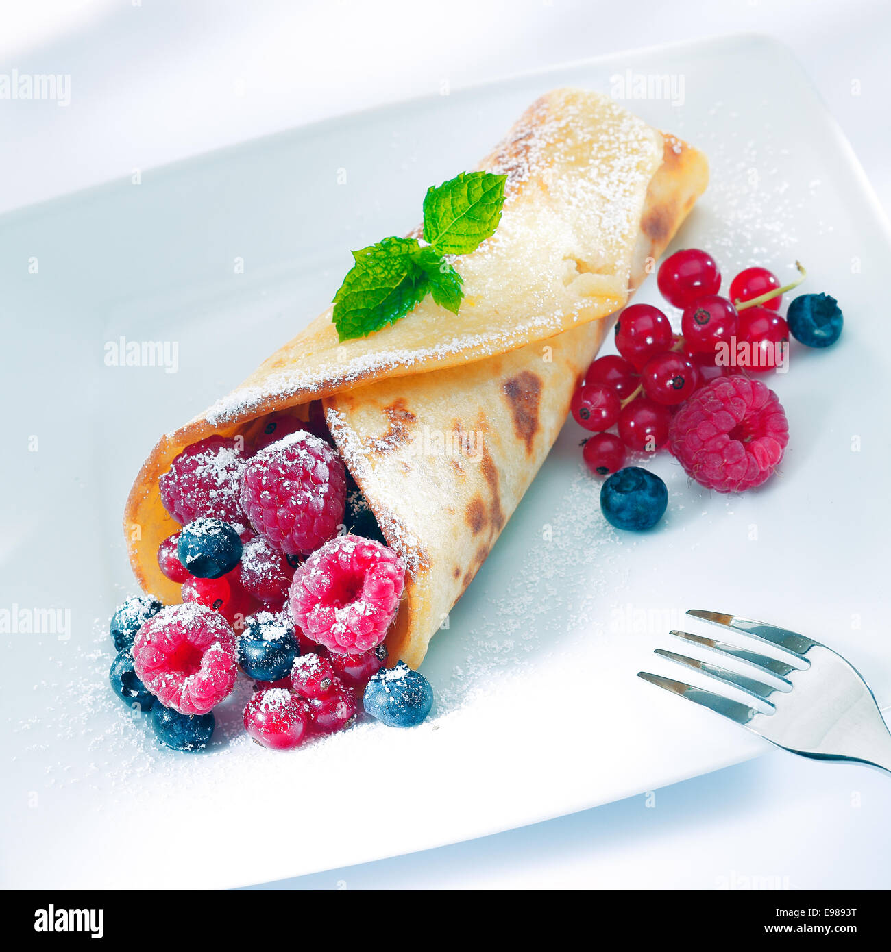 Pancakes Raspberry Blueberries Mint Berry pancake sprinkled with sugar with an assortment or ripe ...