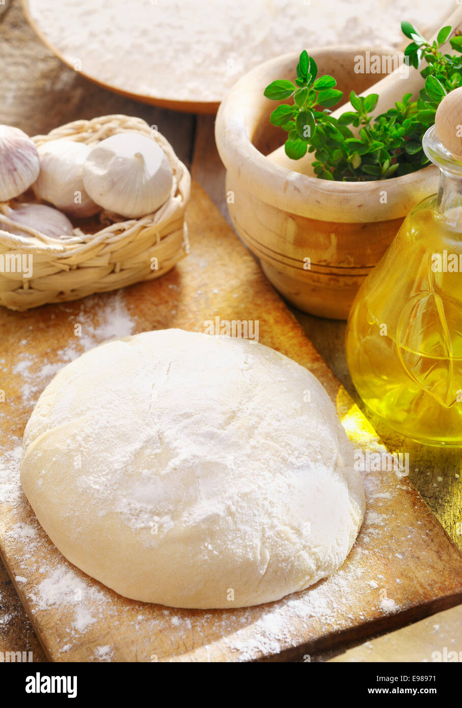 Dough and ingredients for preparing a delicious homemade Italian pizza Stock Photo