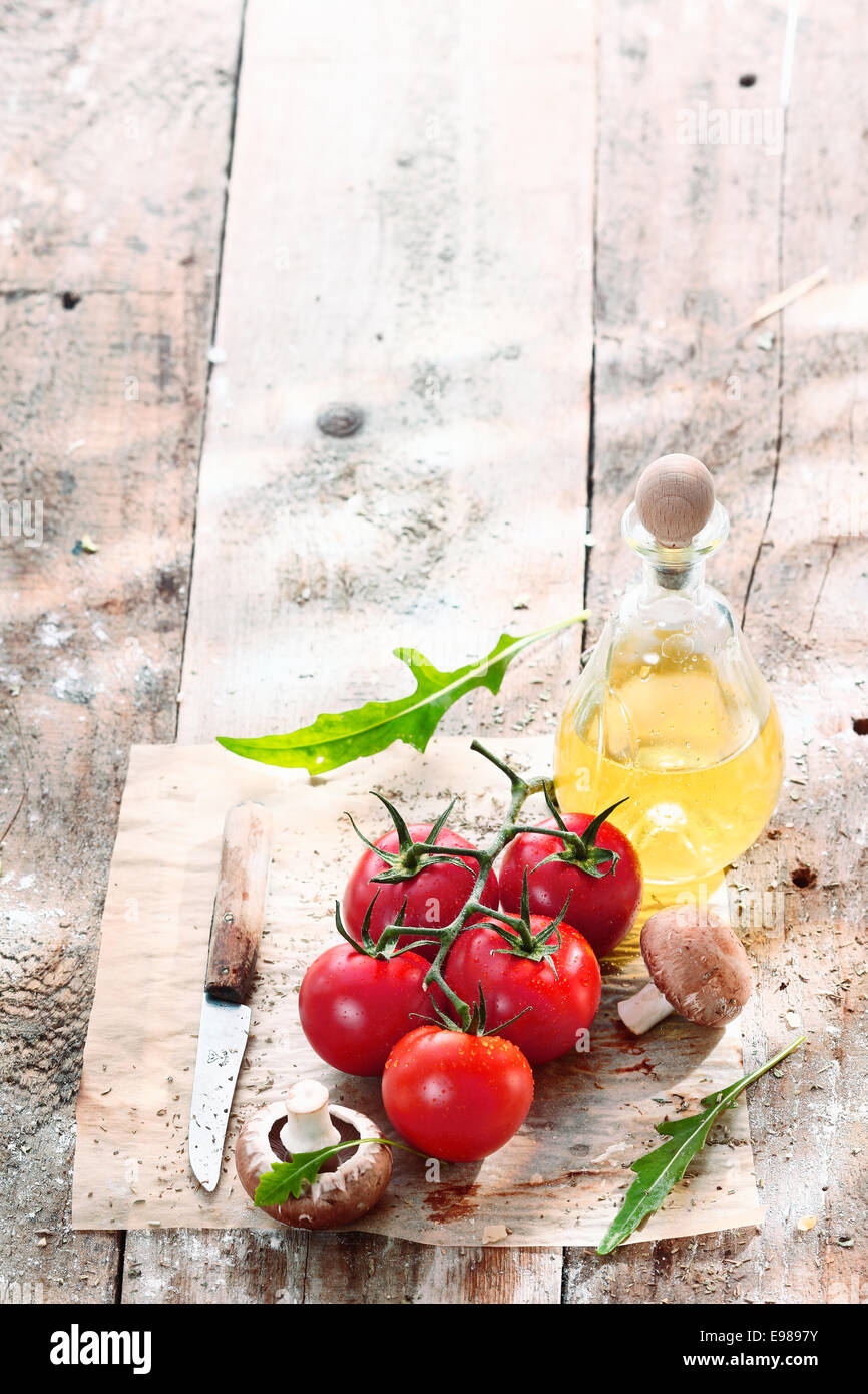 Fresh cooking ingredients in a grungy kitchen on an old vintage wooden table Stock Photo