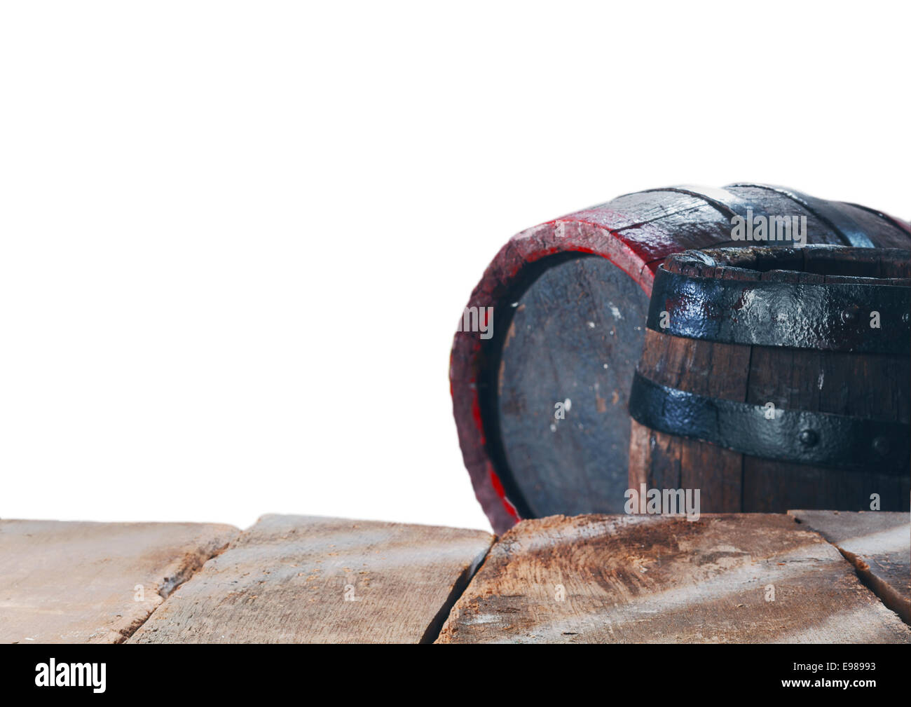 Old stained oak wine or beer barrels with metal bands behind an empty