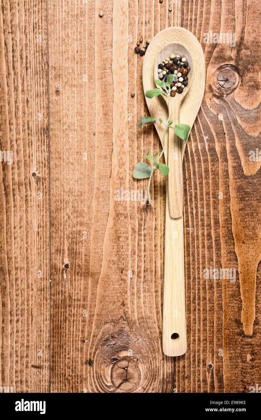 Brown wooden spoon and a sprig of green Stock Photo