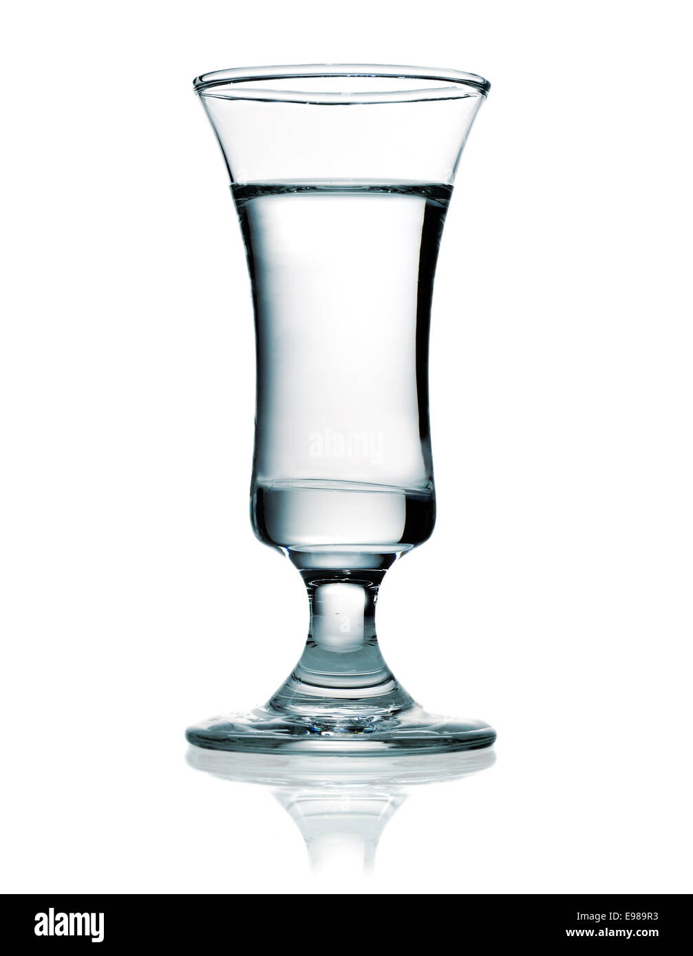 Shot glass filled with vodka which is a distilled beverage and one of the most popular alcoholic drinks Stock Photo
