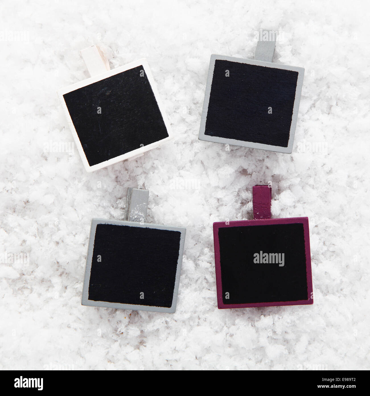 Four empty retro instant photo frames on snow for your collection of Christmas or seasonal images or messages Stock Photo