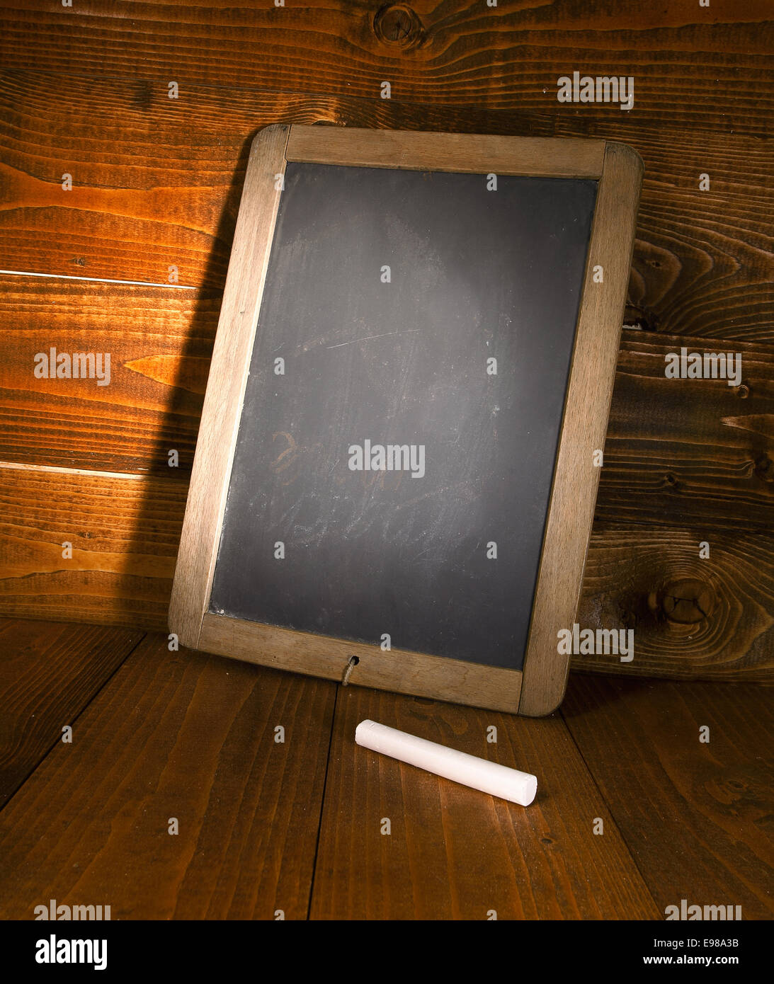 Blank menu board with a piece of chalk, on a wooden background Stock Photo