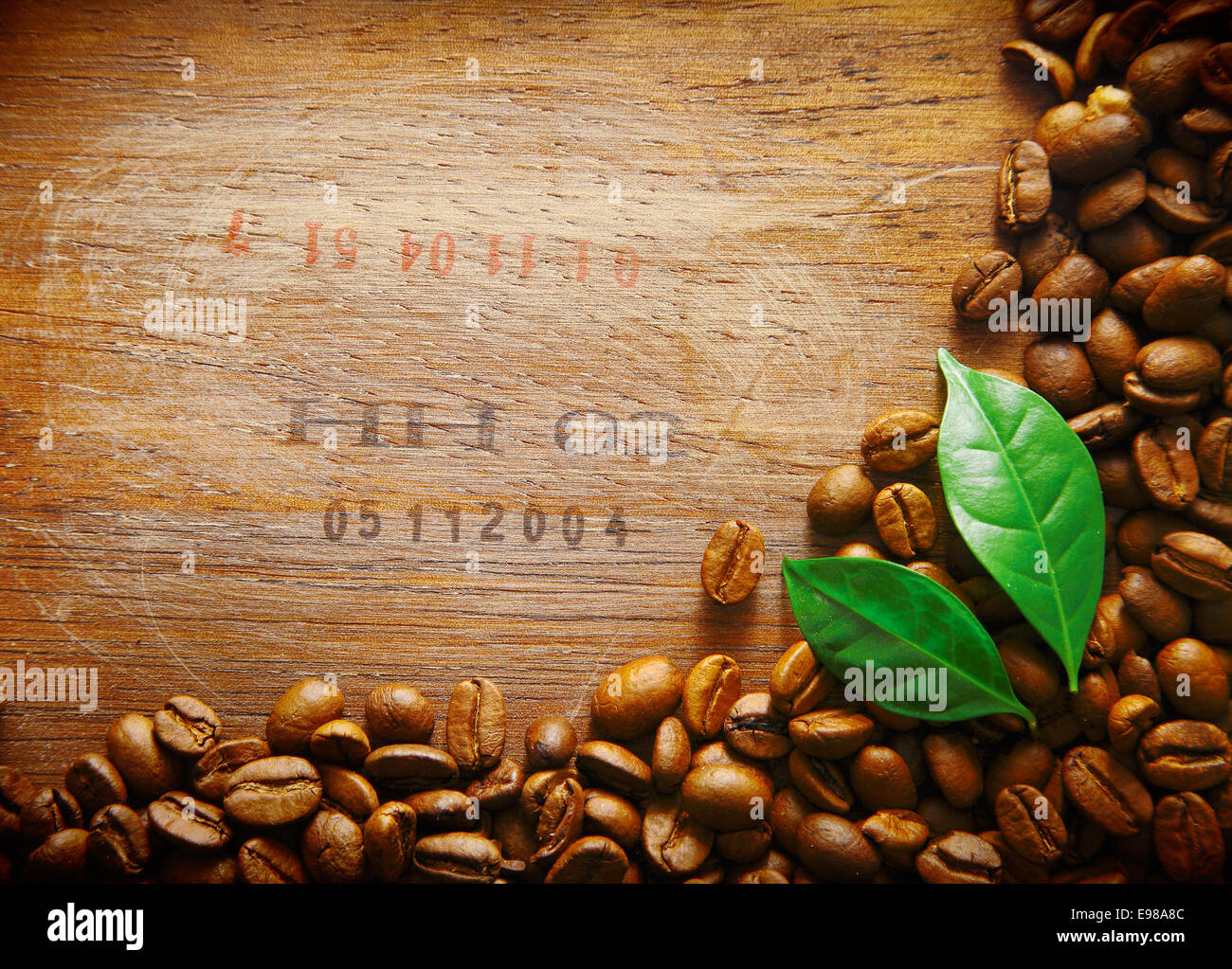 Coffee Bean Border On An Old Wood Surface With Stamped Numbers From A Shipment Of Beans Two Green Leaves Coffee Bean Border On An Old Wood Surface With Stamped Numbers From A Shipment Of Beans Two Green Leaves