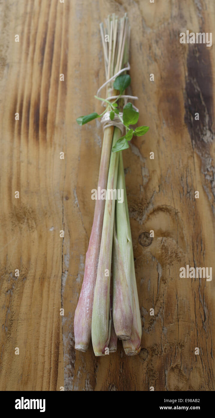 Bunch of lemon grass with majoram on a wooden plate Stock Photo