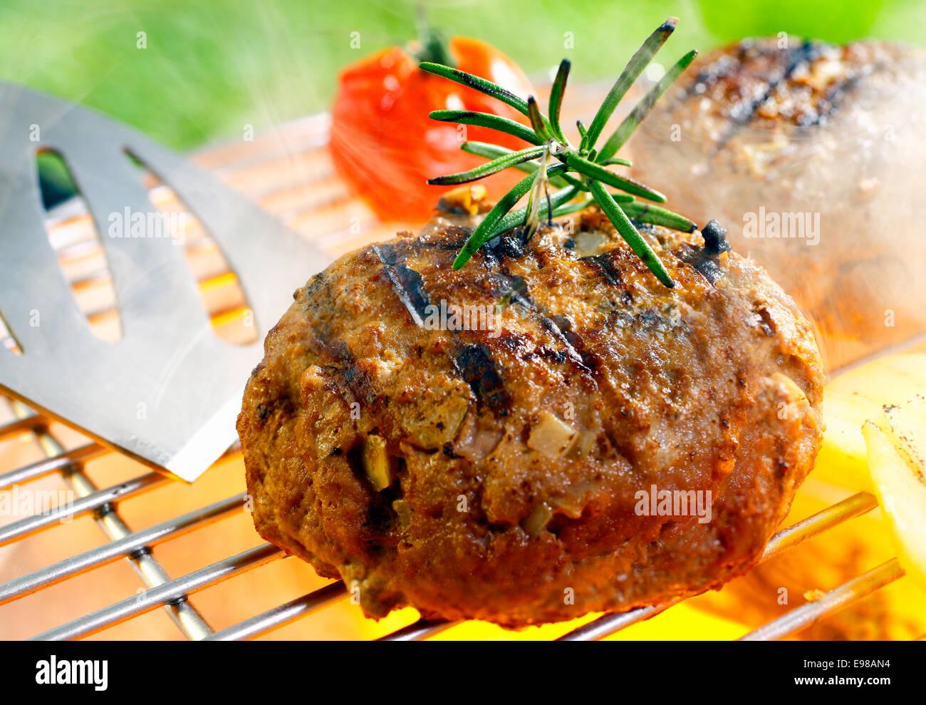 Hamburger patty grilling on the barbecue isolated on Stock Photo Alamy