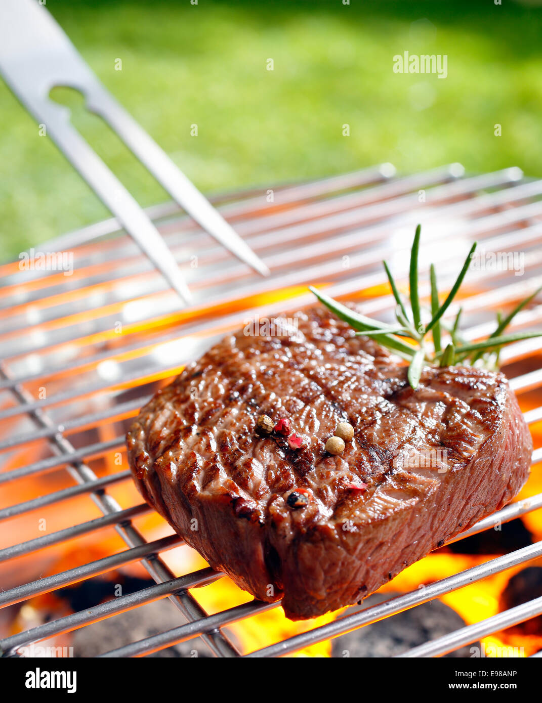 Grilled beef steak on the grilling pan outdoors Stock Photo