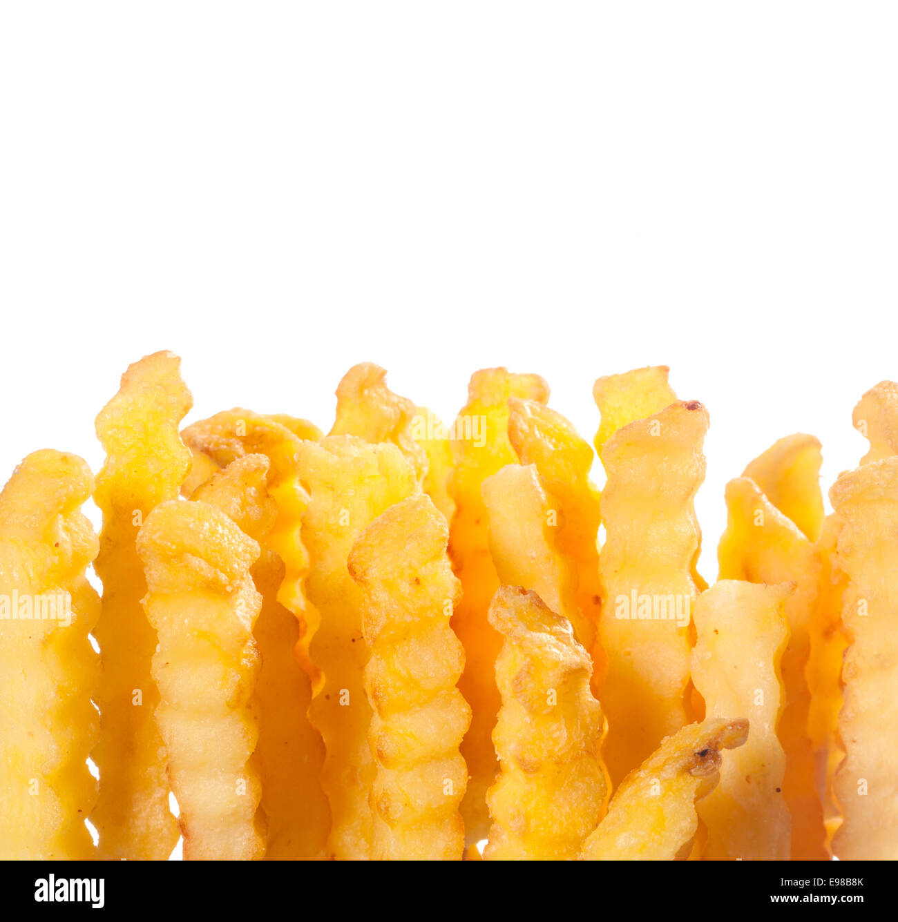 Crinkle cut wavy deep fried golden potato chips for an unhealthy