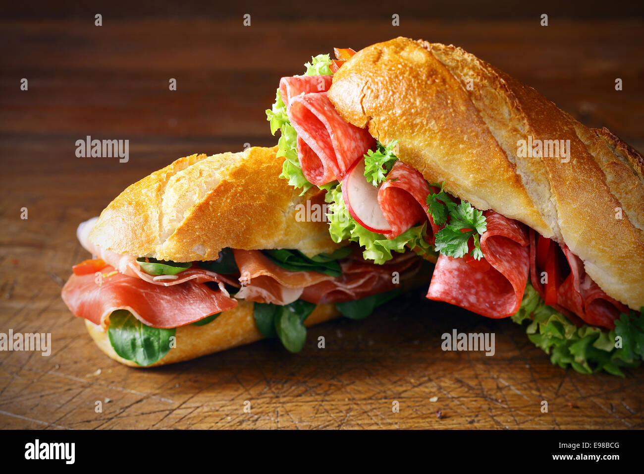 Freshly baked crisp golden baguettes filled with ham and basil or