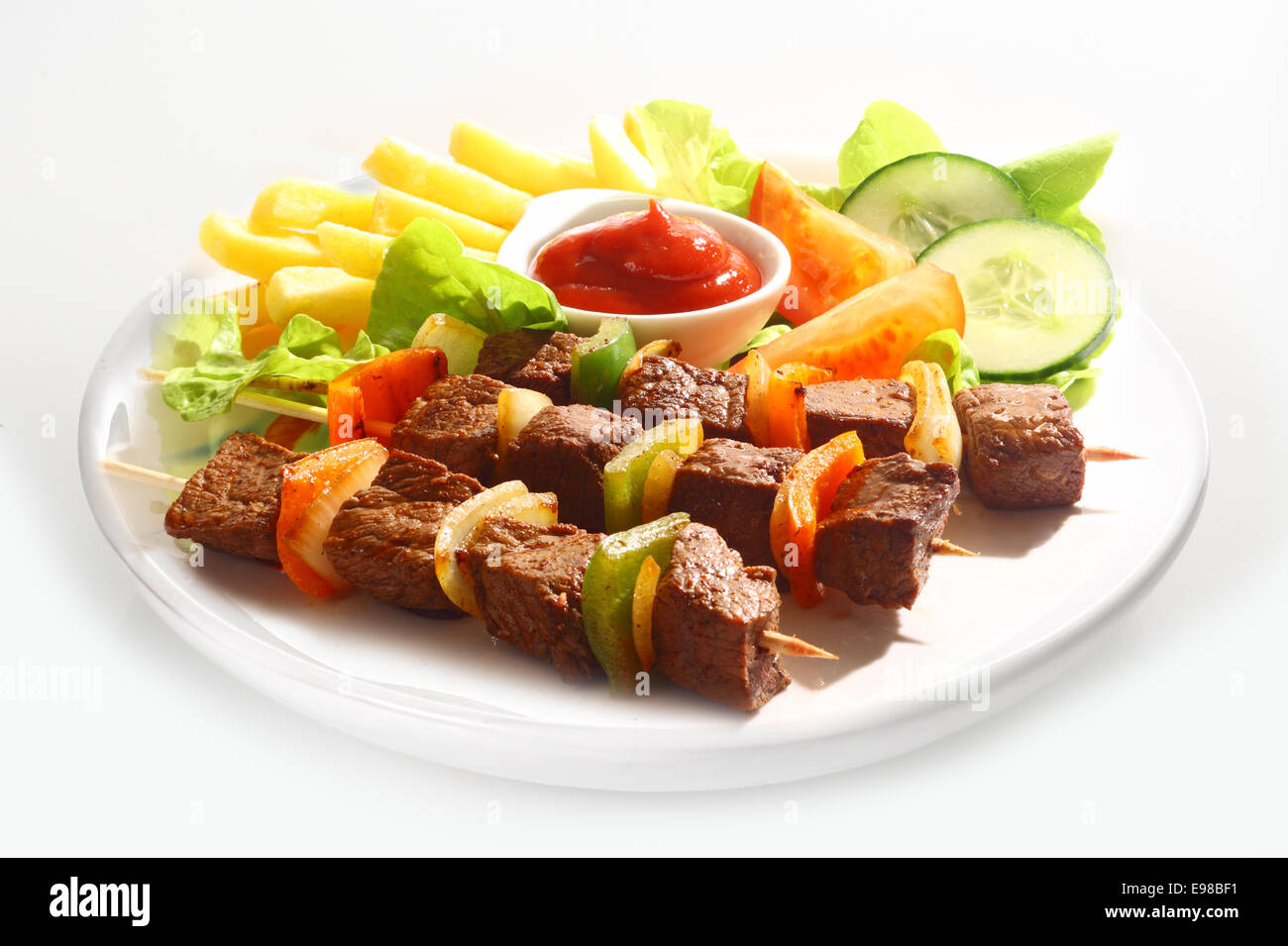Three grilled beef and sweet pepper kebabs served on a plain white
