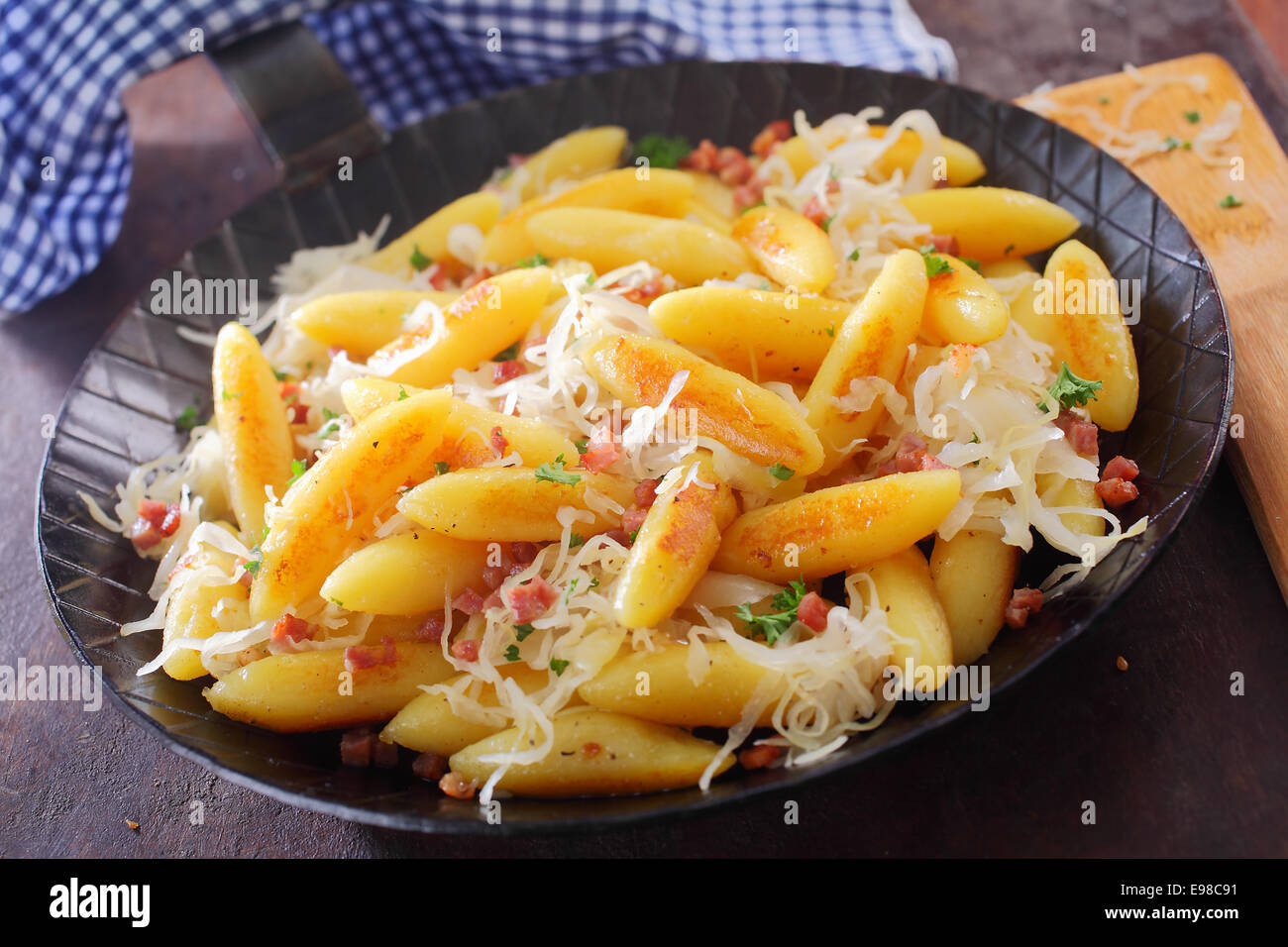 Golden fried fingershaped potato dumplings and noodles in a rustic
