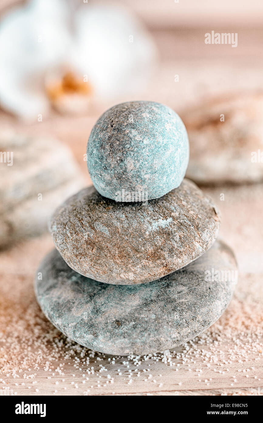 Carefully balanced and stacked naturally rounded water worn Zen stones at a marine spa conceptual of spirituality, therapy, wellness, relaxation and meditation Stock Photo
