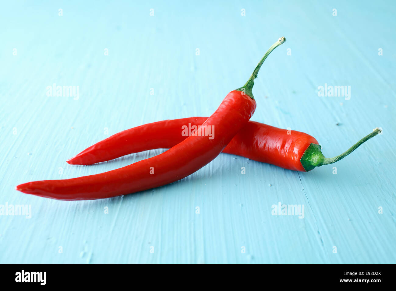 Two red hot jalapeno chili peppers used as a pungent spicy ingredient