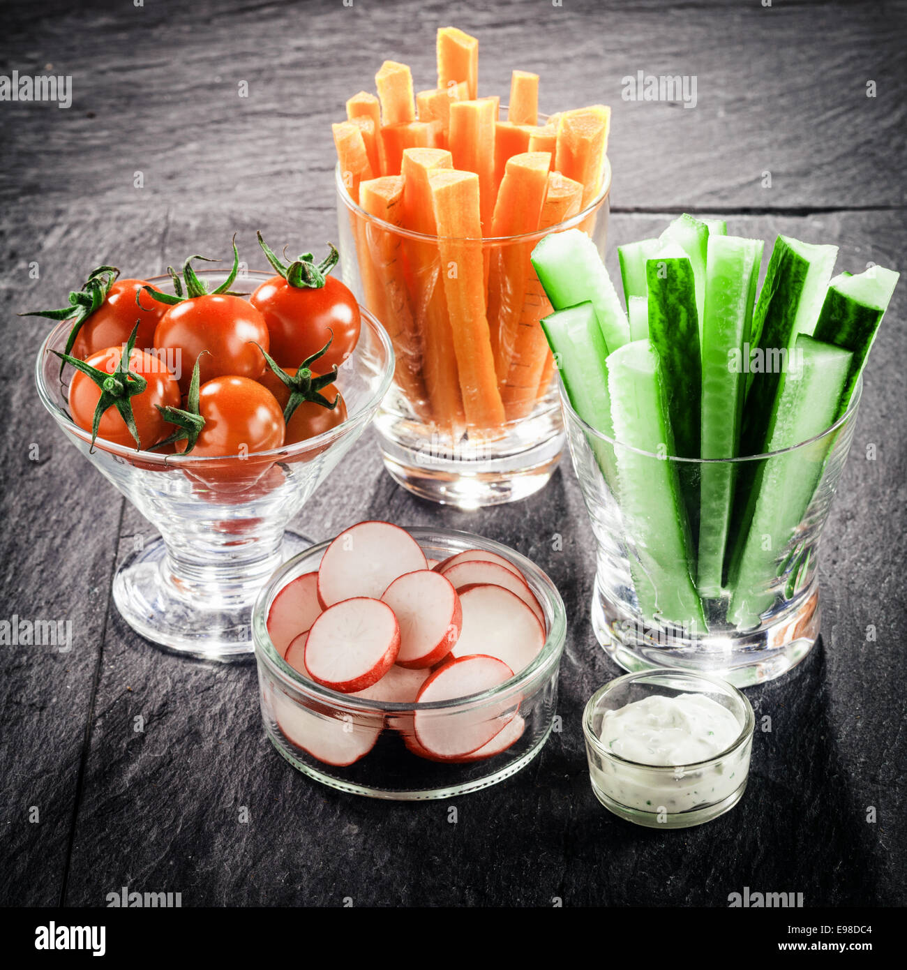 Serving of fresh vegetable crudites on a buffet with individual glass