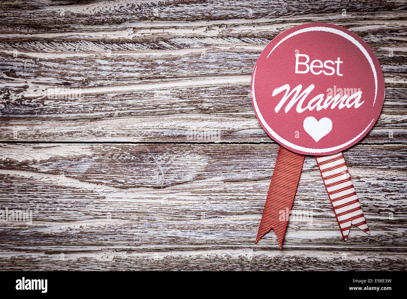 Round purple rosette with the text Best Mama for a loving mothers day or baby shower greeting celebrating a special mother on a Stock Photo