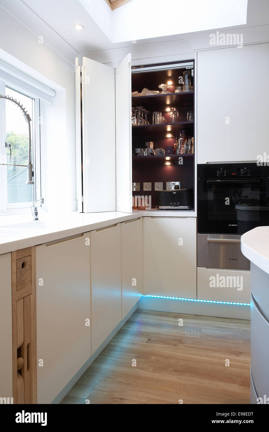 A Modern White Kitchen Inside A Home In The Uk With Folding